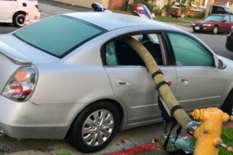 When firefighters found a car between them and the hydrant they needed water from, they broke...