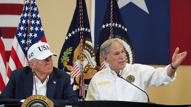 Texas Gov. Greg Abbott speaks as President Donald Trump listens during a roundtable discussion...