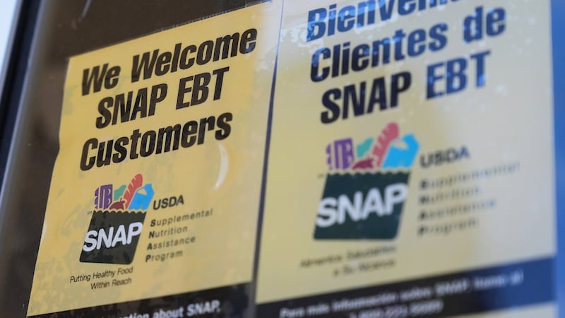 FILE - A SNAP EBT information sign is displayed outside of a convenience store in Baltimore,...