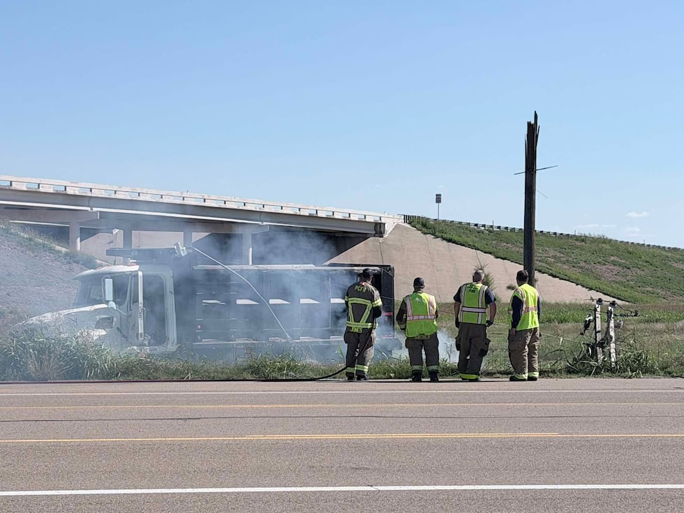 Crews are working to put out a fire after a truck hit a pole near Highway 136 and Loop 335.